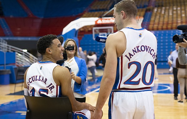 Kansas guard Michael Jankovich (20) jokingly cuts in during an interview with Kansas guard Kevin McCullar Jr. (15) to ask him questions about his Halloween plans on Tuesday, Oct. 25, 2022 at Allen Fieldhouse.
