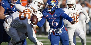 Kansas quarterback Jalon Daniels (6) scrambles to get away from the Texas defense during the second quarter on Saturday, Nov. 19, 2022 at Memorial Stadium.