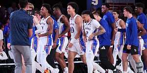 The Jayhawks line up to shake hands with Wisconsin after Bobby Pettiford (0) hit a wild shot to win it with 0.2 seconds to play in overtime at the Bad Boy Mower’s Men’s Battle 4 Atlantis at Atlantis, Paradise Island in The Bahamas. (Photo by Tim Aylen)