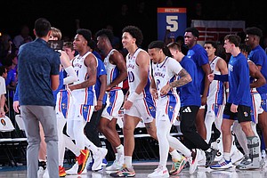 The Jayhawks line up to shake hands with Wisconsin after Bobby Pettiford (0) hit a wild shot to win it by 0.2 seconds to go into overtime at Bad Boy Mower's Men's Battle 4 Atlantis at Atlantis, Paradise Island in the Bahamas.  (Photo by Tim Aylen)