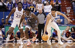 Kansas guard Kevin McCuller Jr., 15, pushes the ball onto the court against Seton Hall in the second half on Thursday, Dec. 1, 2022 at Allen Fieldhouse.