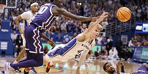 Kansas guard Grady Dick (4) meets TCU guard Damion Boe (10) during the first half of an NCAA college basketball game at Allen Fieldhouse in Lawrence, Kansas, Saturday, Jan. 21, 2023. and loose balls are available.  This is Rondell Walker (11) from the TCU guard.  (AP Photo/Nick Krug)