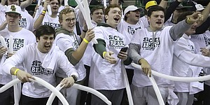 Baylor students react as their team scores in the first half of an NCAA college basketball game against Kansas Monday, January 23, 2023 in Waco, Texas.  (AP Photo/Jerry Larson)